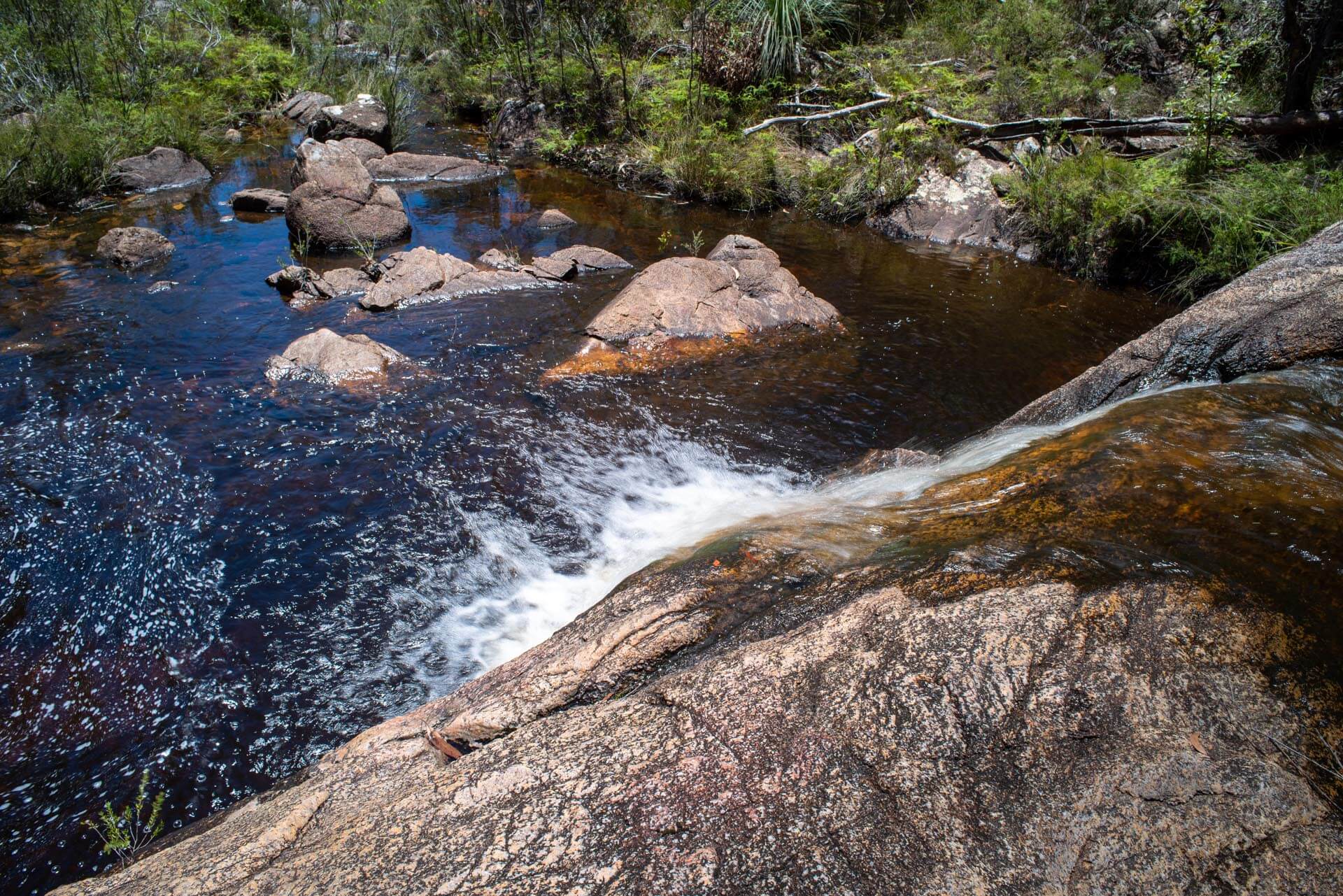 Natural waterway cascading over granite boulders
